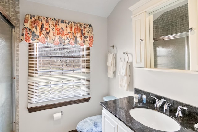 bathroom with a shower with door and vanity