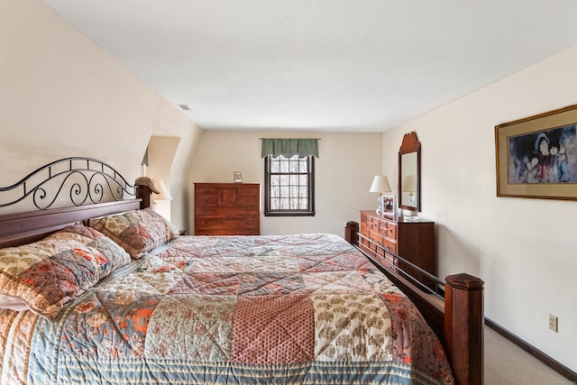 carpeted bedroom featuring baseboards and visible vents