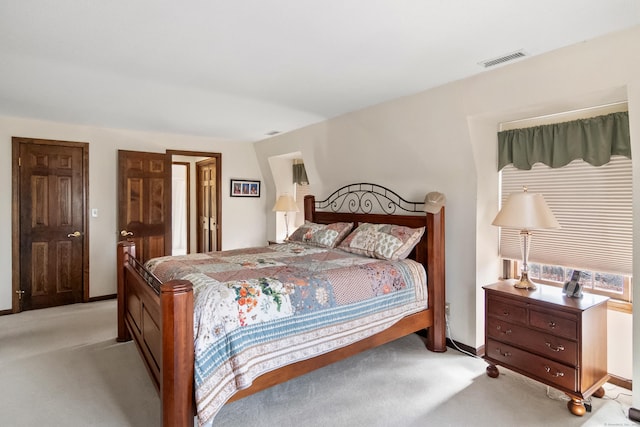 bedroom featuring light colored carpet, visible vents, and baseboards