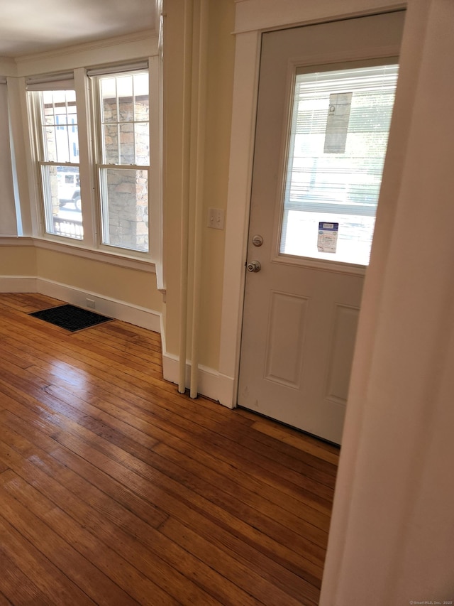 foyer entrance with baseboards and wood-type flooring