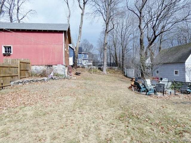 view of yard with an outdoor structure and fence