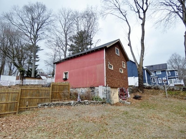 view of home's exterior featuring fence