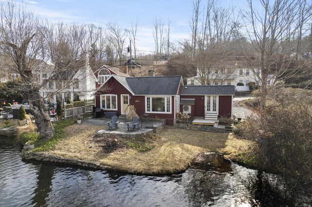 exterior space with a patio, fence, a shingled roof, and entry steps