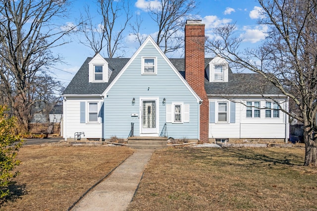 view of front of home with a front lawn, a chimney, and a shingled roof