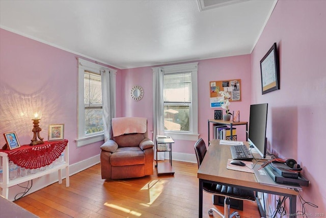 home office featuring light wood-style floors, baseboards, and a wealth of natural light