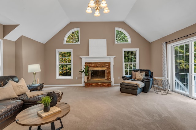 carpeted living area with a brick fireplace, baseboards, a chandelier, and high vaulted ceiling