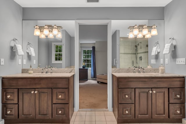 bathroom with a sink, two vanities, a stall shower, and tile patterned floors