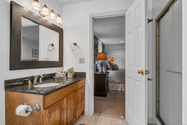 ensuite bathroom featuring tile patterned floors, vanity, and ensuite bathroom