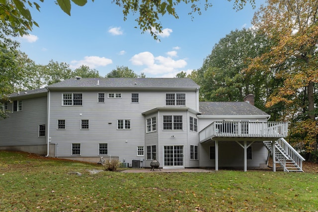 rear view of property with a wooden deck, a yard, a chimney, stairs, and a patio area