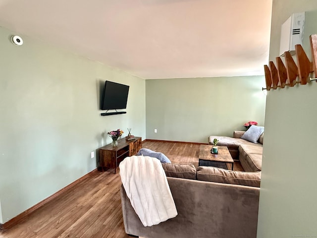 living room featuring baseboards and wood finished floors