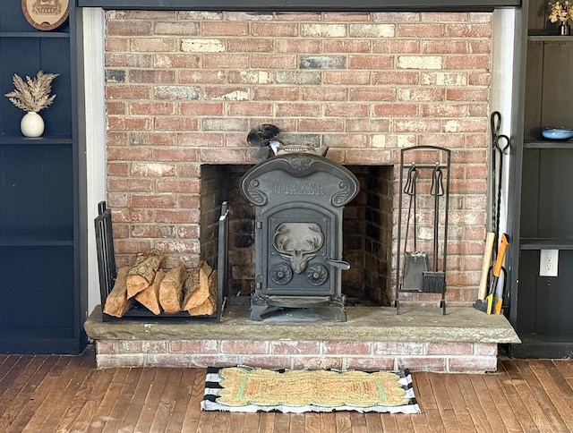 details with a wood stove and wood finished floors