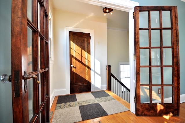 entryway with baseboards and wood-type flooring