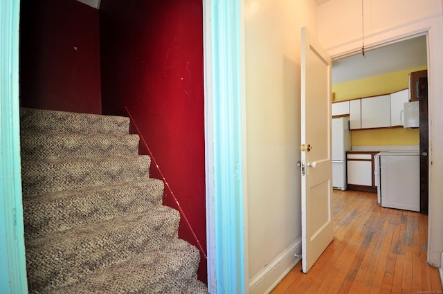 stairway with hardwood / wood-style floors