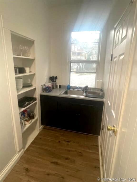 interior space featuring dark wood-type flooring, light countertops, and a sink