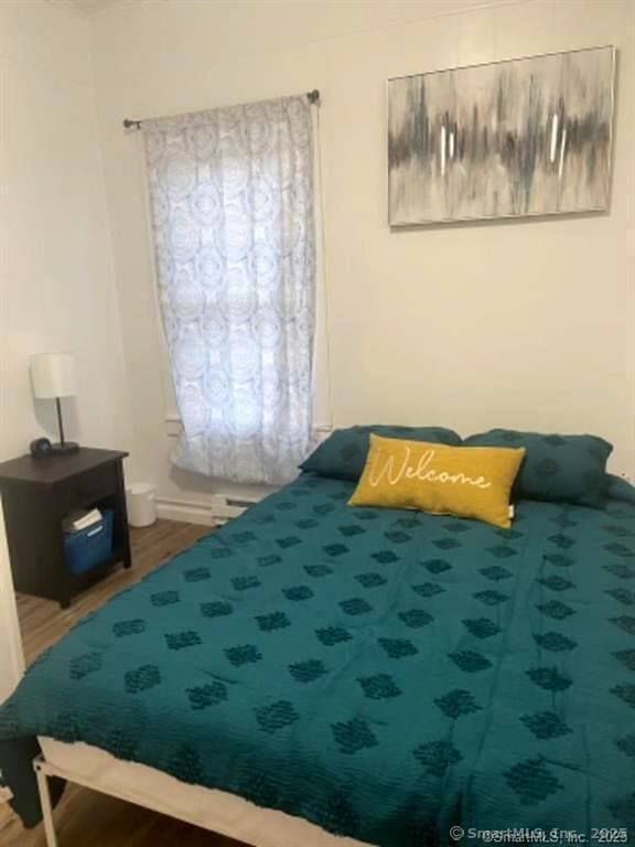 bedroom featuring wood finished floors