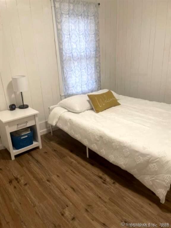 bedroom featuring dark wood finished floors