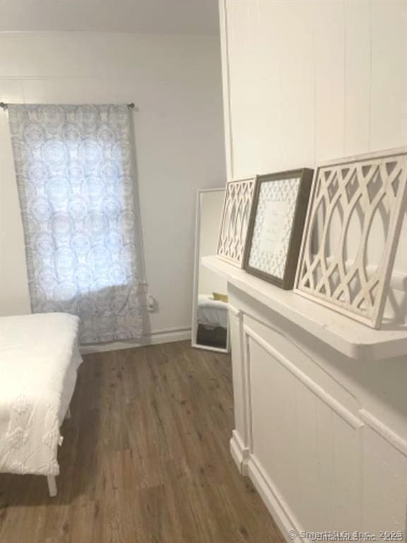 bedroom featuring dark wood finished floors and baseboards