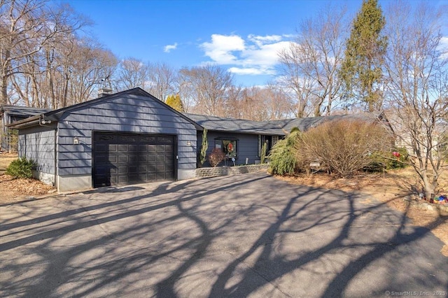 ranch-style house with an attached garage and driveway