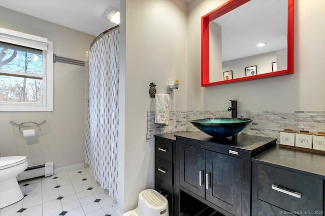 full bathroom with vanity, baseboards, decorative backsplash, a baseboard heating unit, and toilet