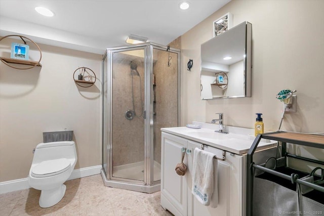 bathroom featuring toilet, a stall shower, recessed lighting, baseboards, and vanity