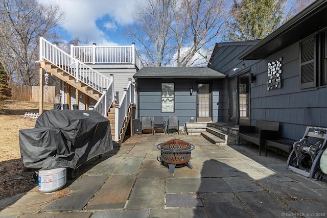 view of patio featuring a fire pit and fence