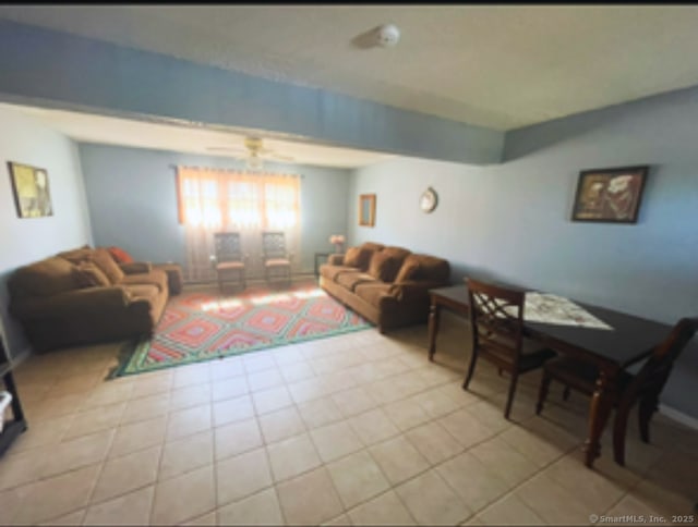 living room with light tile patterned floors and a ceiling fan