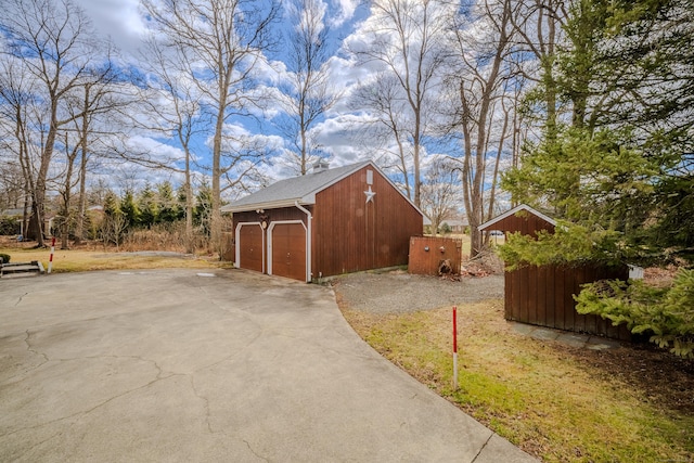 view of home's exterior featuring a garage and an outdoor structure