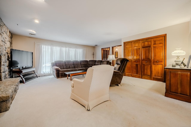 carpeted living area featuring visible vents