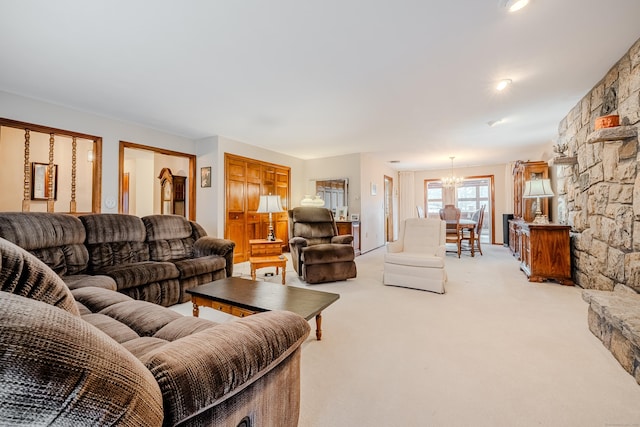 living area with light colored carpet and a chandelier