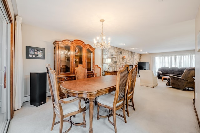 dining space with a notable chandelier, baseboard heating, and light carpet