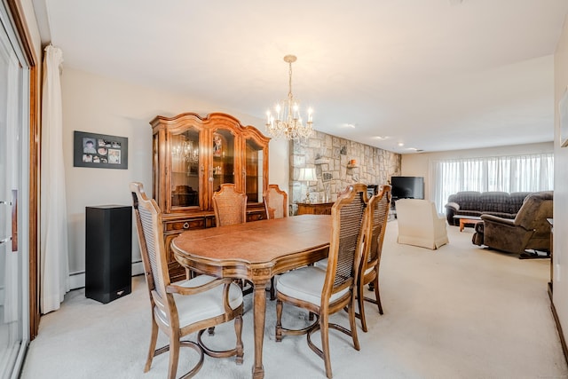 dining area with baseboard heating, a chandelier, and light colored carpet
