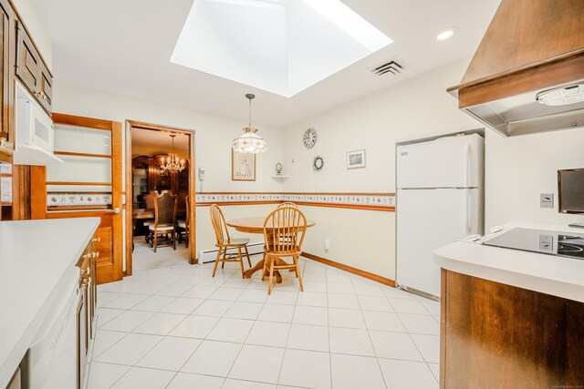 kitchen featuring white appliances, visible vents, custom exhaust hood, a skylight, and light countertops