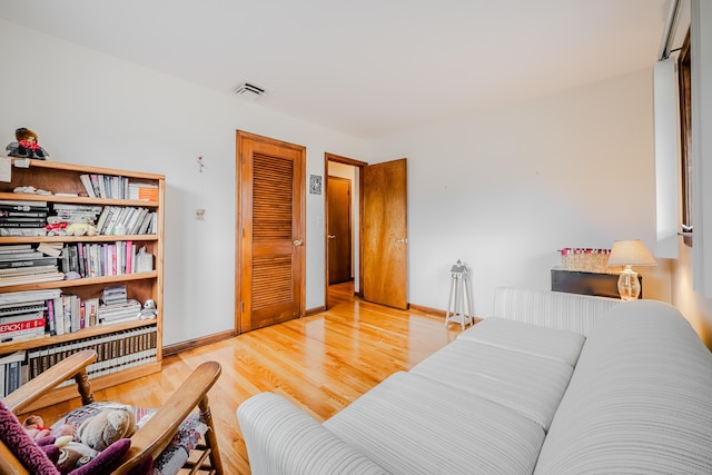 interior space featuring visible vents, baseboards, and wood finished floors