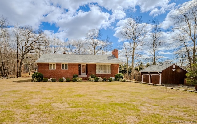 ranch-style home featuring an outdoor structure, a chimney, a front lawn, and brick siding