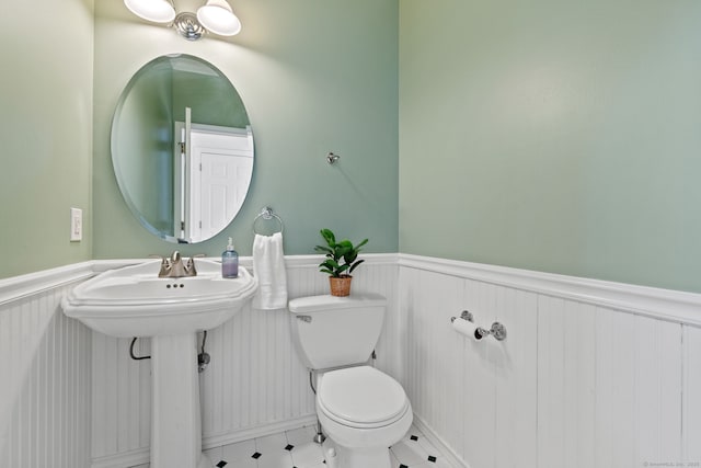 bathroom featuring wainscoting and toilet