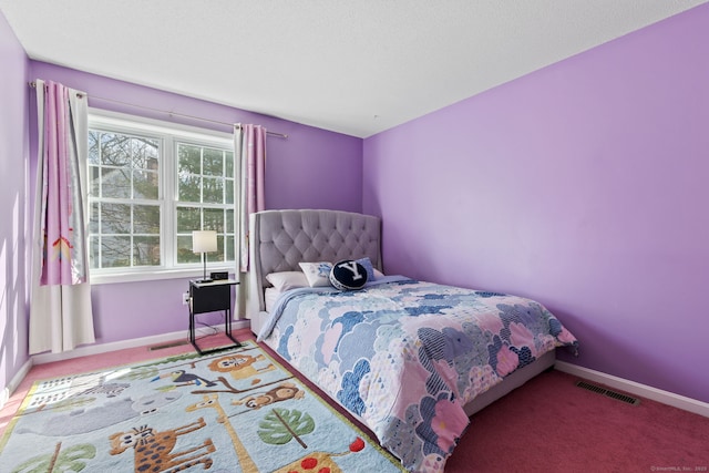 carpeted bedroom featuring baseboards and visible vents