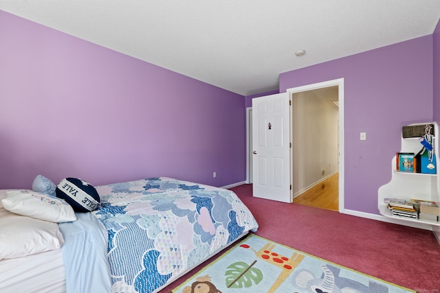 carpeted bedroom with baseboards