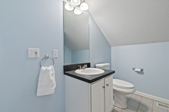 bathroom featuring visible vents, toilet, vanity, lofted ceiling, and a textured ceiling