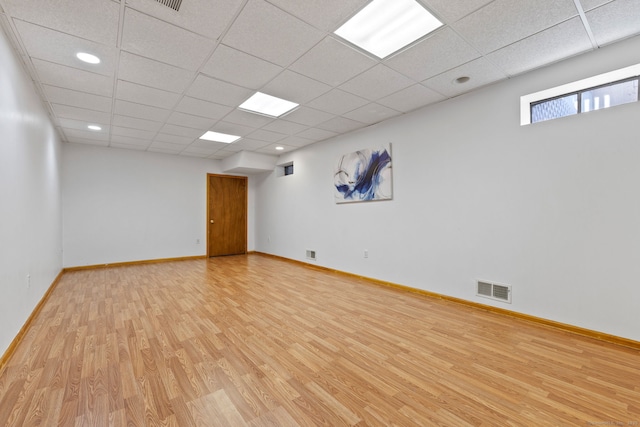 empty room featuring light wood-style flooring, baseboards, and visible vents