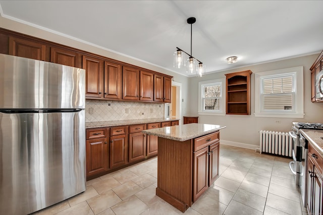 kitchen featuring tasteful backsplash, radiator, a kitchen island, brown cabinets, and appliances with stainless steel finishes