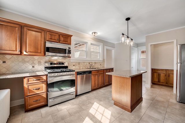 kitchen featuring backsplash, radiator heating unit, brown cabinets, stainless steel appliances, and a sink