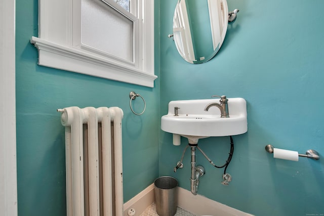 bathroom featuring radiator heating unit and baseboards