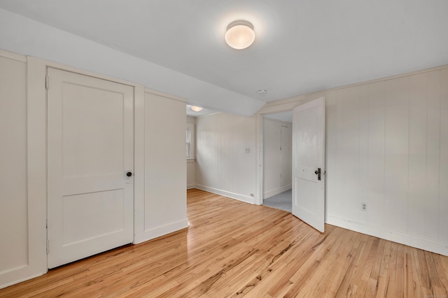 unfurnished bedroom featuring baseboards and light wood-style flooring