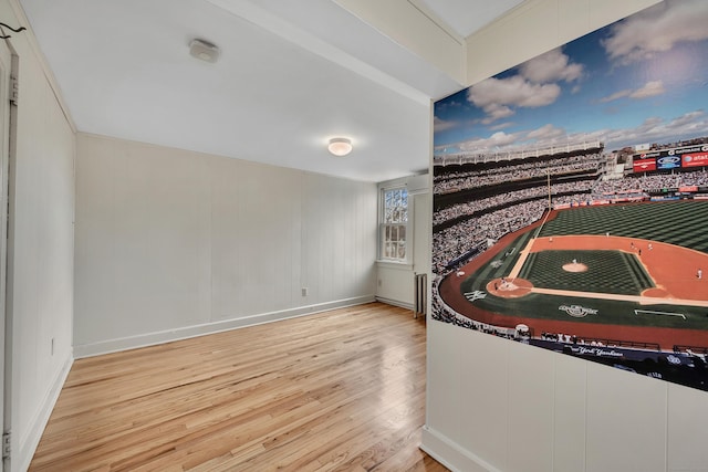 interior space with wood finished floors and baseboards