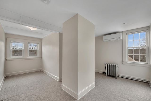 carpeted empty room featuring a wall mounted air conditioner, baseboards, radiator, and a wealth of natural light