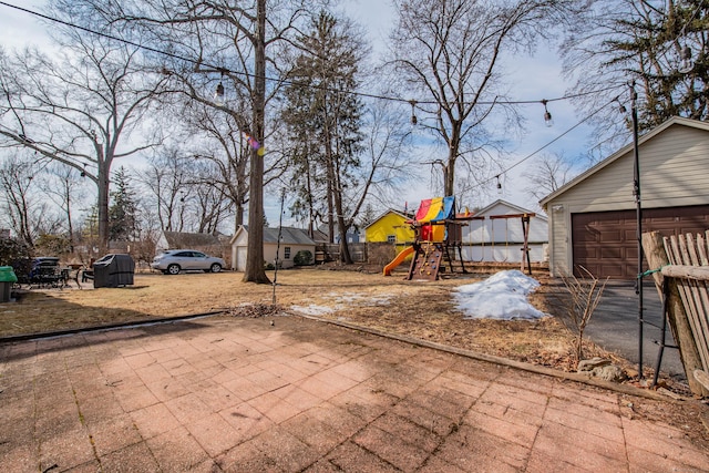 view of yard featuring an outbuilding and a playground