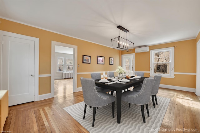 dining area with radiator, light wood-style flooring, and ornamental molding