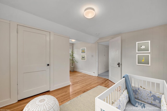 bedroom with baseboards and light wood finished floors