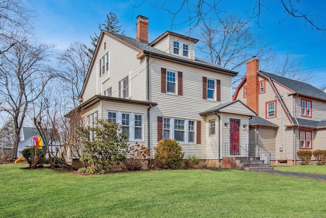 traditional style home featuring a chimney and a front yard