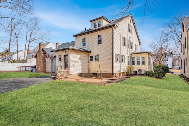 back of house featuring a yard and fence